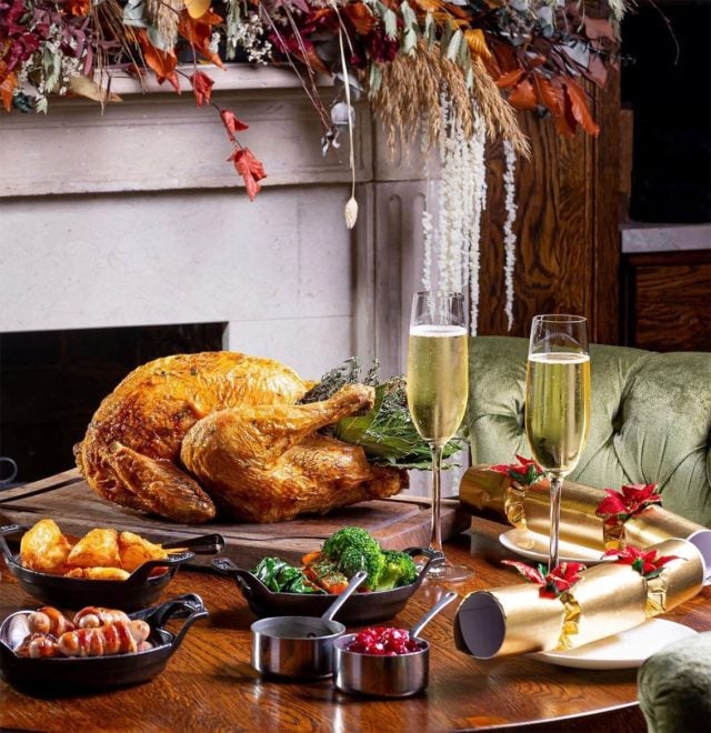 Table set with turkey, trimmings and champagne