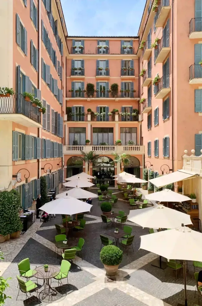 View from the outside seating area inbetween the narrow sqaured pink Hotel de Russie